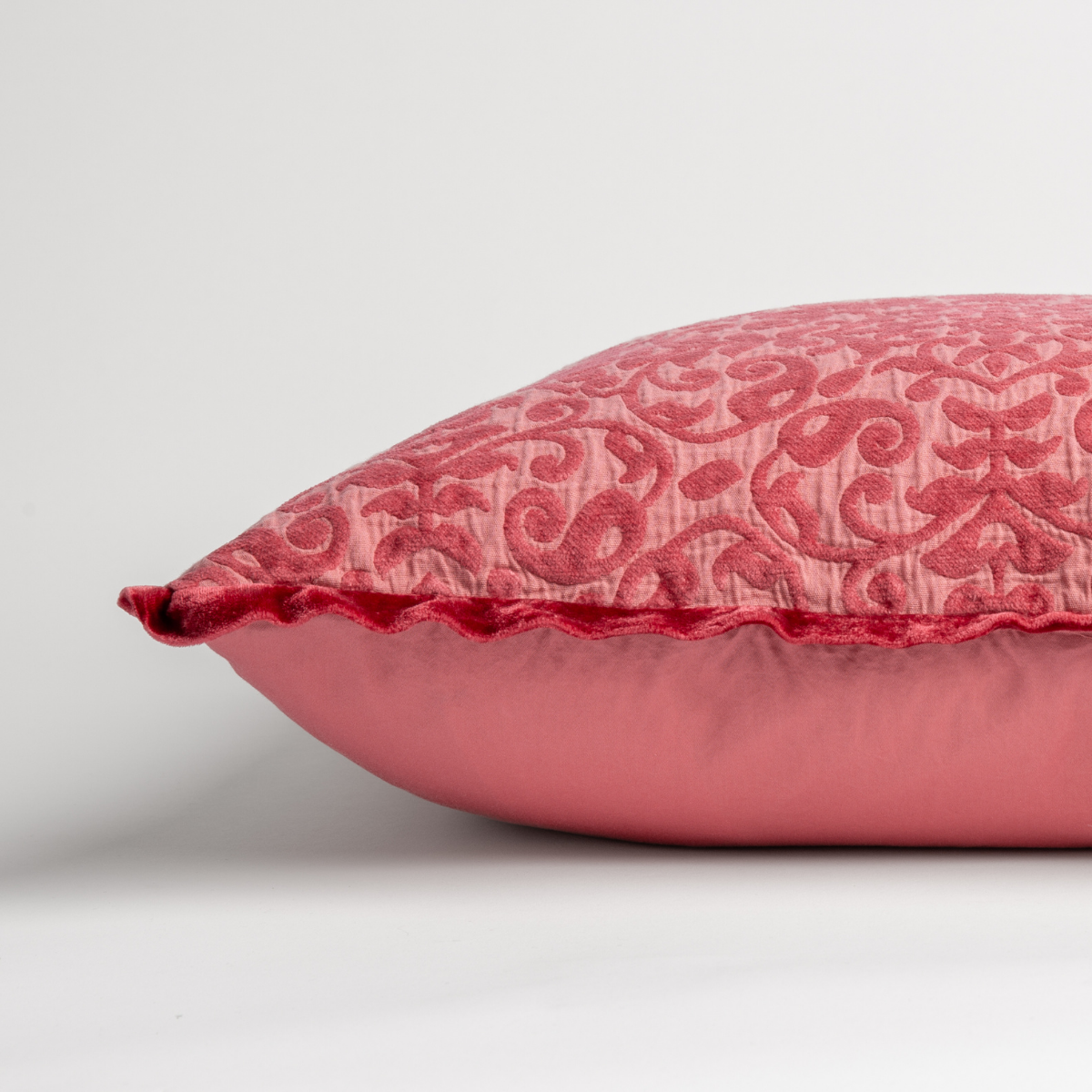 Poppy: side view of 18x18 pillow shows cotton sateen back and silk velvet trim detail — close up against a white background. 