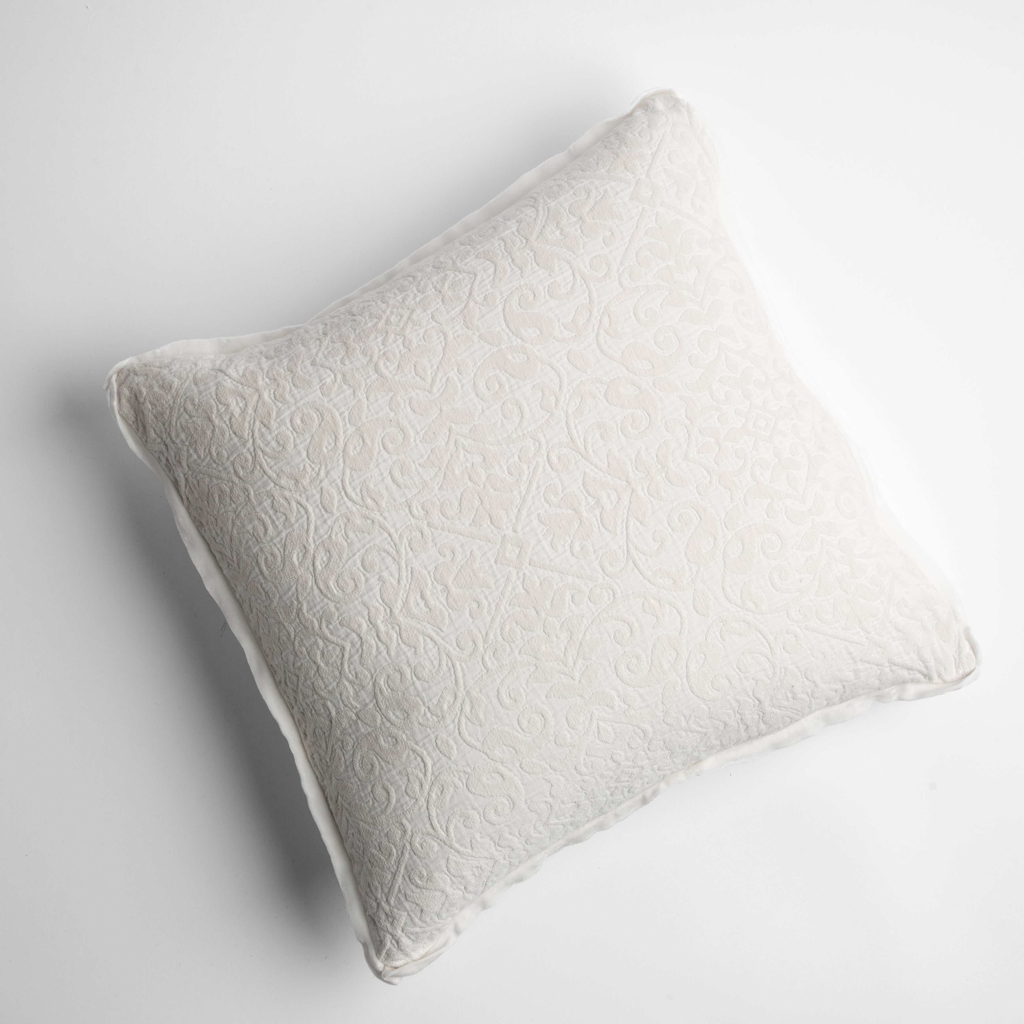 Winter White: cotton chenille jacquard 18x18 pillow shown from overhead to display the pillow's face and silk velvet trim — overhead against a white background.