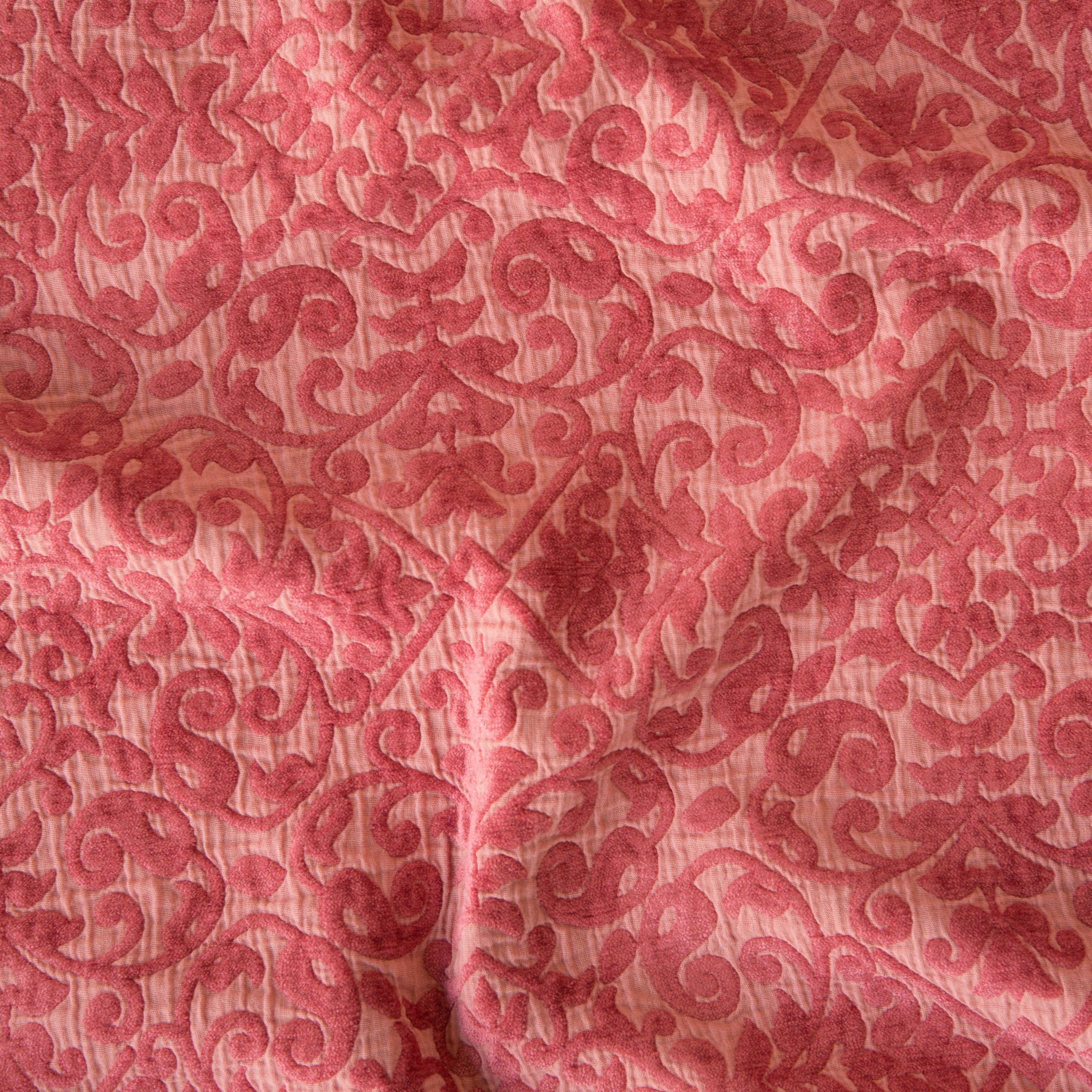 Poppy: A close up of Vienna cotton chenille jacquard in poppy, a warm coral pink. 