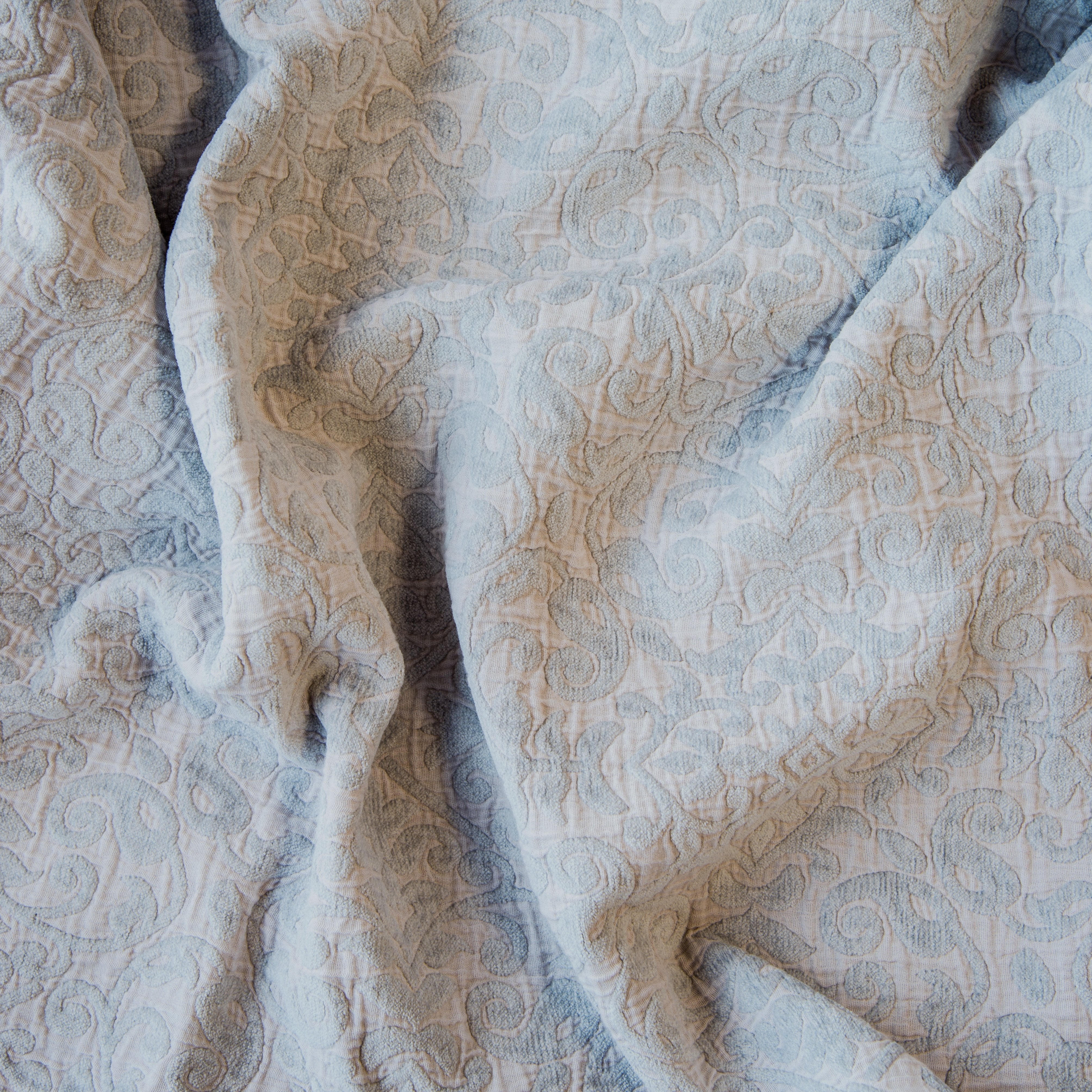 Sterling: A close up of Vienna cotton chenille jacquard in sterling, a silvery neutral light grey. 